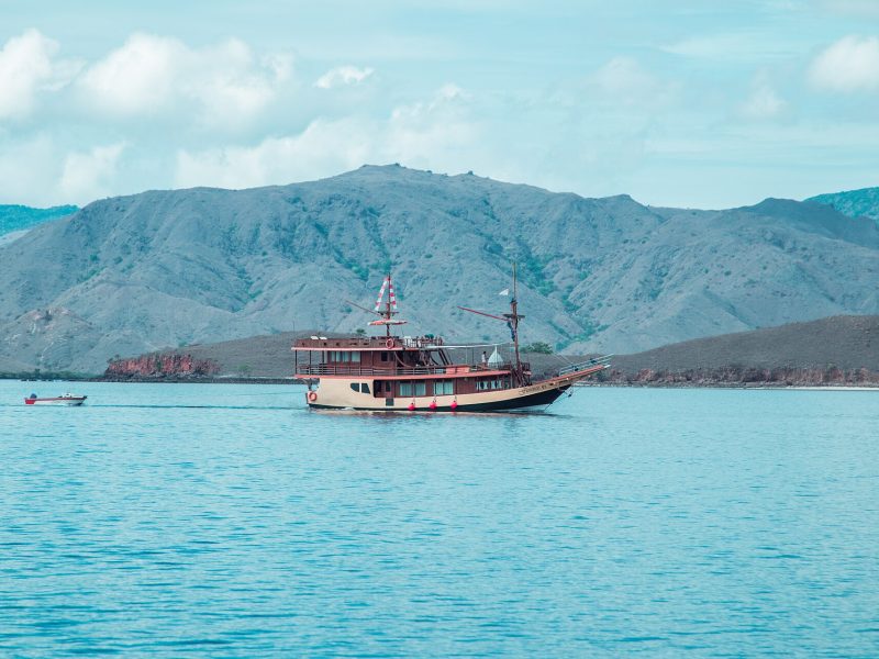 Traditional wooden phinisi sailing boat anchored in the bay of Labuan Bajo, Flores